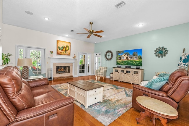 living room with recessed lighting, wood finished floors, visible vents, a fireplace, and ceiling fan