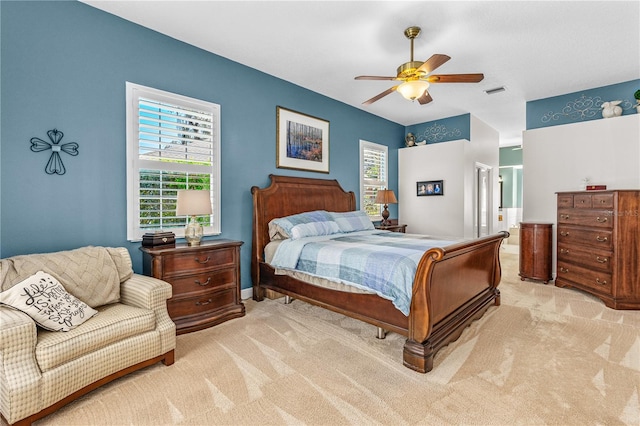 carpeted bedroom with visible vents and a ceiling fan