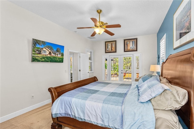 bedroom with a ceiling fan, a textured ceiling, light carpet, french doors, and baseboards