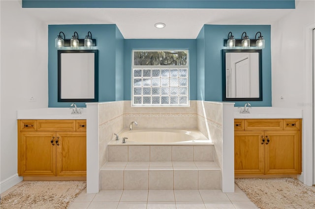 bathroom with a garden tub, two vanities, tile patterned floors, and a sink