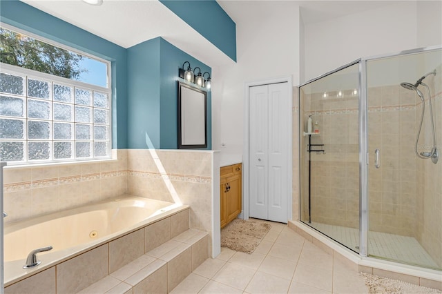 full bathroom with tile patterned floors, a garden tub, vanity, and a stall shower
