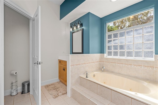 full bath with tile patterned floors, baseboards, vanity, and a tub with jets