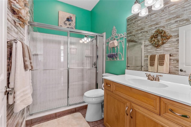 bathroom with toilet, a notable chandelier, and a stall shower