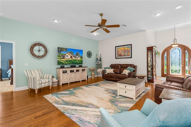 living room with visible vents, baseboards, recessed lighting, a ceiling fan, and wood finished floors