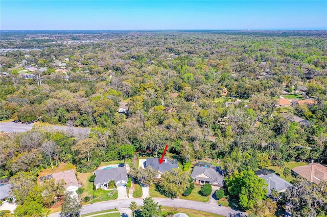 birds eye view of property featuring a view of trees