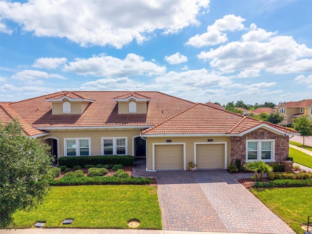 1079 Quaker Ridge Ln, Davenport, FL 33896 - mediterranean / spanish house featuring a front lawn, stucco siding, a tiled roof, and an attached garage
