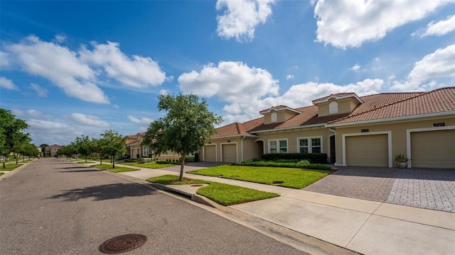 1079 Quaker Ridge Ln, Davenport, FL 33896 - view of front of house with a garage, a front lawn, stucco siding, and driveway