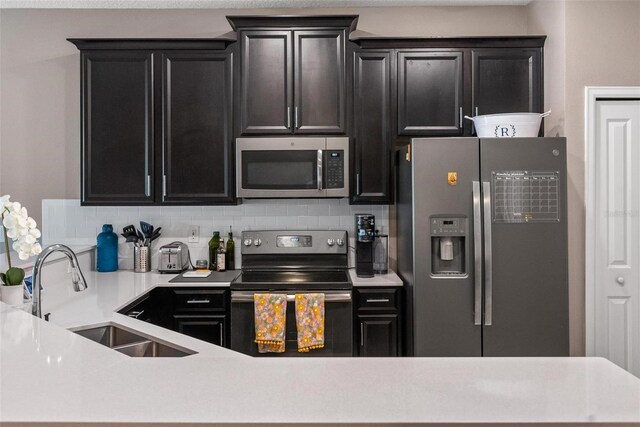 1079 Quaker Ridge Ln, Davenport, FL 33896 - kitchen with appliances with stainless steel finishes, dark cabinets, and a sink