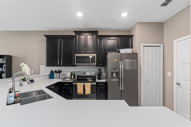 1079 Quaker Ridge Ln, Davenport, FL 33896 - kitchen with appliances with stainless steel finishes, visible vents, light countertops, and a sink
