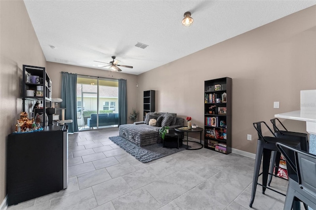 1079 Quaker Ridge Ln, Davenport, FL 33896 - living room with a textured ceiling, ceiling fan, baseboards, and visible vents