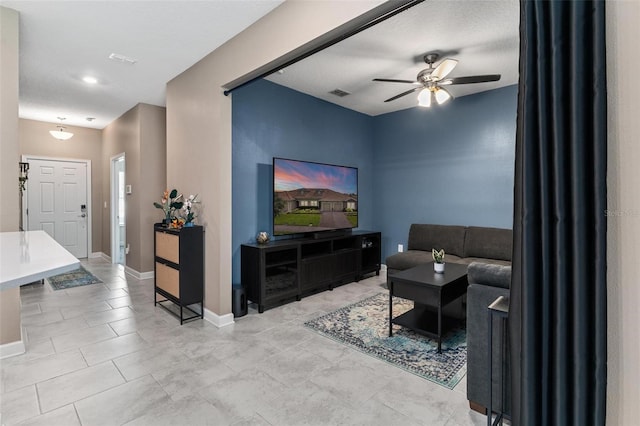 1079 Quaker Ridge Ln, Davenport, FL 33896 - living room featuring light tile patterned floors, visible vents, a ceiling fan, and baseboards