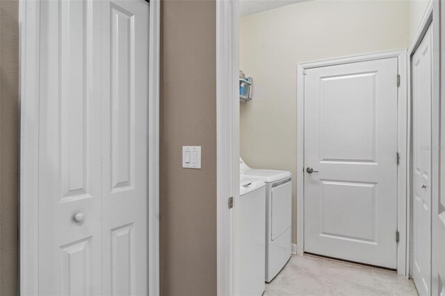 1079 Quaker Ridge Ln, Davenport, FL 33896 - laundry room featuring light tile patterned floors, washing machine and dryer, and laundry area