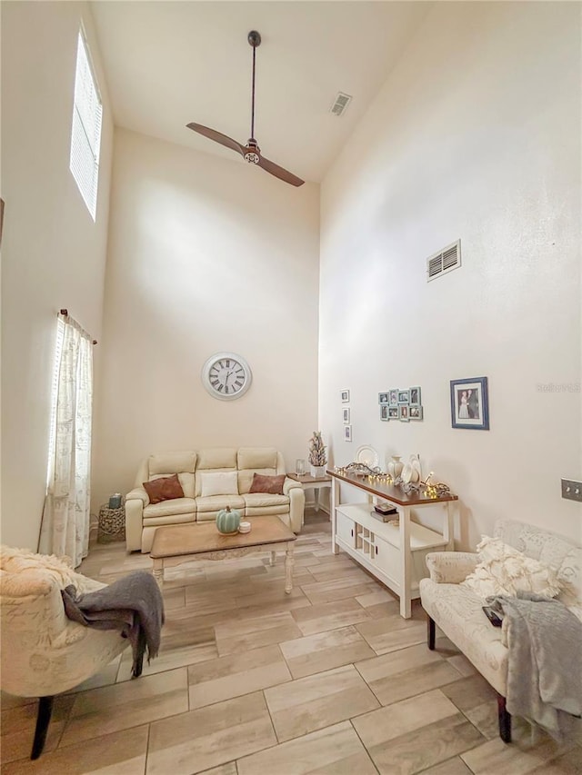 103 Manor View Ln, Deland, FL 32724 - living area with high vaulted ceiling, a ceiling fan, and visible vents