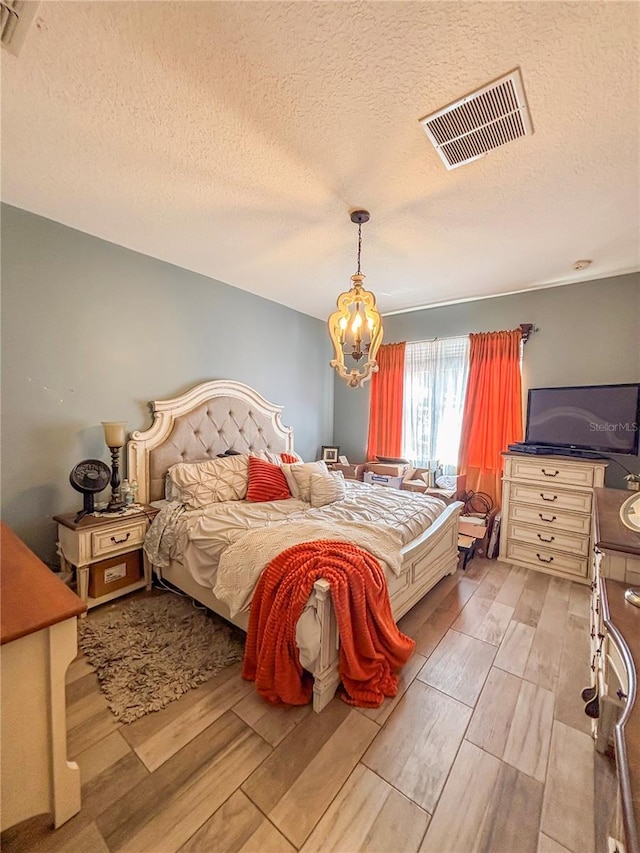 103 Manor View Ln, Deland, FL 32724 - bedroom featuring a textured ceiling, visible vents, and light wood-style flooring