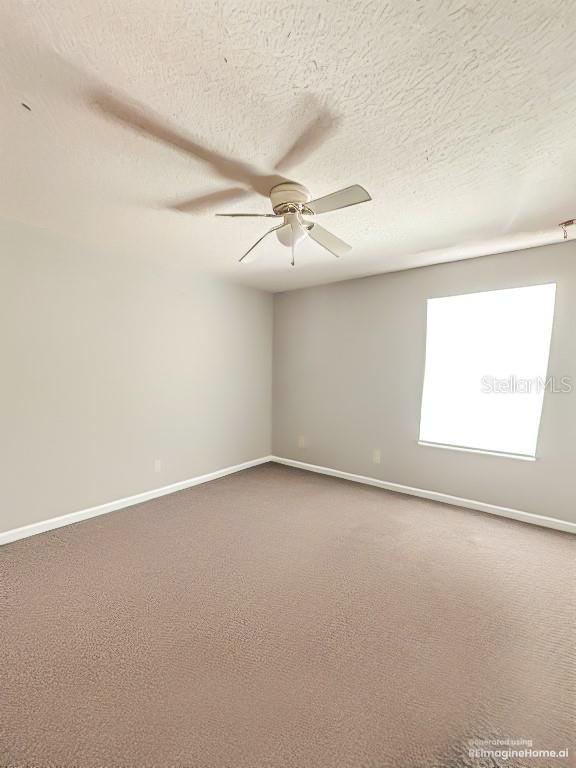 103 Manor View Ln, Deland, FL 32724 - unfurnished room with carpet floors, ceiling fan, and baseboards