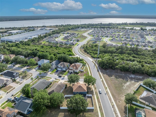 drone / aerial view featuring a residential view and a water view
