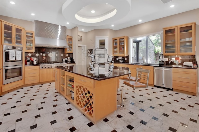 kitchen featuring stainless steel appliances, light brown cabinetry, dark countertops, and recessed lighting