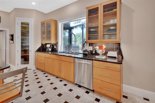 kitchen featuring a sink, stainless steel dishwasher, light brown cabinets, and tasteful backsplash