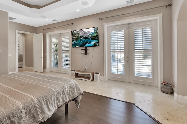 bedroom with french doors, arched walkways, access to outside, baseboards, and tile patterned flooring