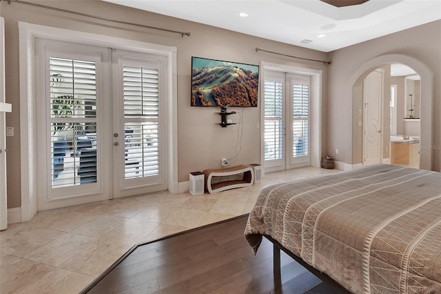 bedroom featuring arched walkways, access to outside, french doors, baseboards, and recessed lighting