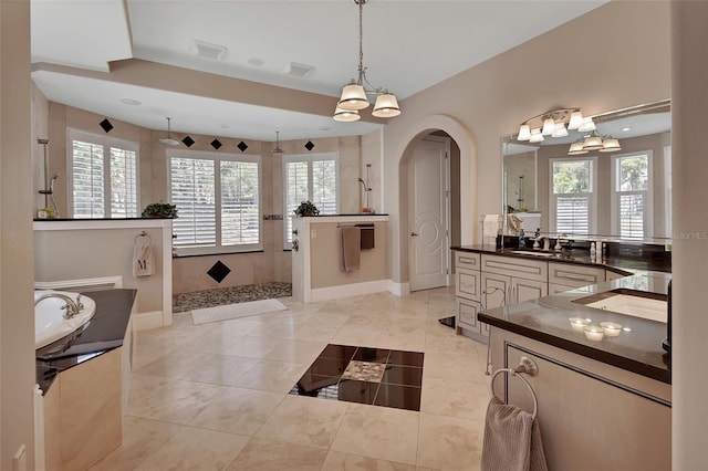 bathroom featuring a chandelier, a walk in shower, and plenty of natural light