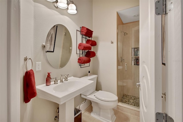 bathroom featuring a stall shower, toilet, and tile patterned floors
