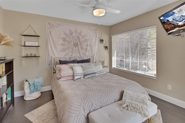 bedroom with wood finished floors, baseboards, and a ceiling fan