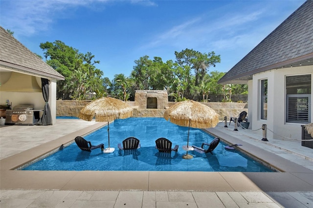 view of swimming pool with a patio and fence