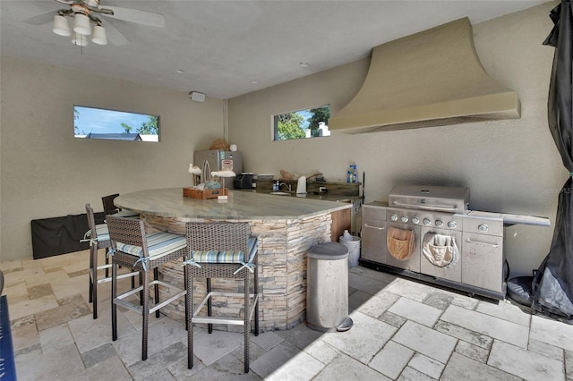 view of patio featuring area for grilling and ceiling fan