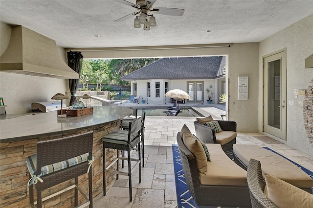 view of patio / terrace featuring an outdoor living space, a grill, an outdoor kitchen, and ceiling fan