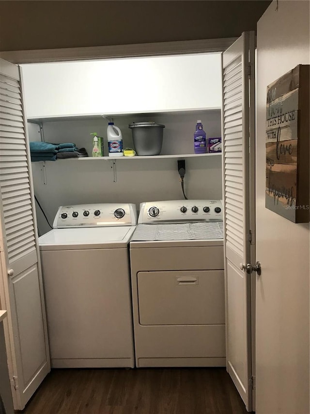clothes washing area featuring dark wood finished floors and independent washer and dryer