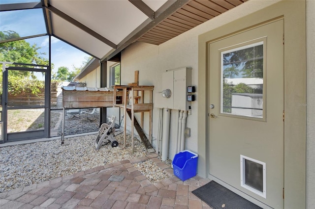 doorway to property with stucco siding and fence