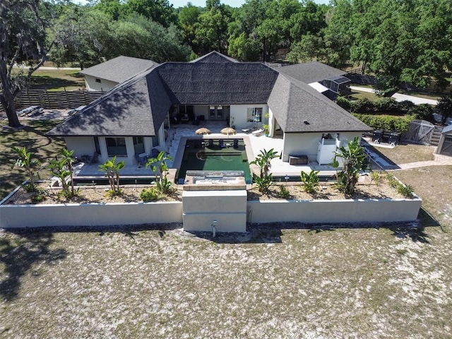 aerial view of property and surrounding area with a tree filled landscape