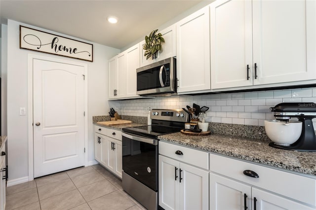 kitchen featuring appliances with stainless steel finishes, tasteful backsplash, white cabinetry, and light tile patterned floors