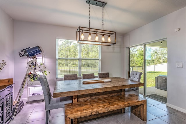 dining space featuring baseboards and light tile patterned floors