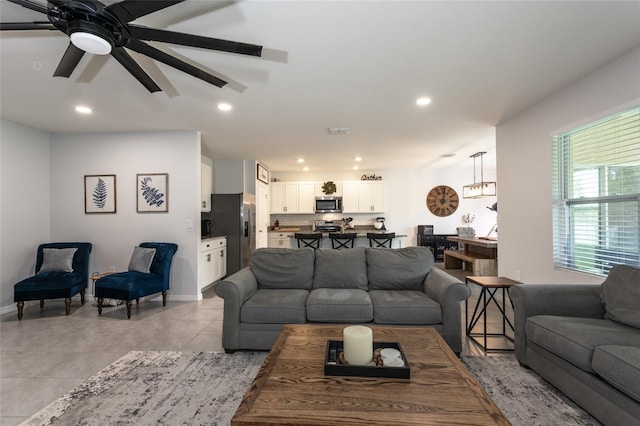 living room with a ceiling fan, light tile patterned flooring, baseboards, visible vents, and recessed lighting