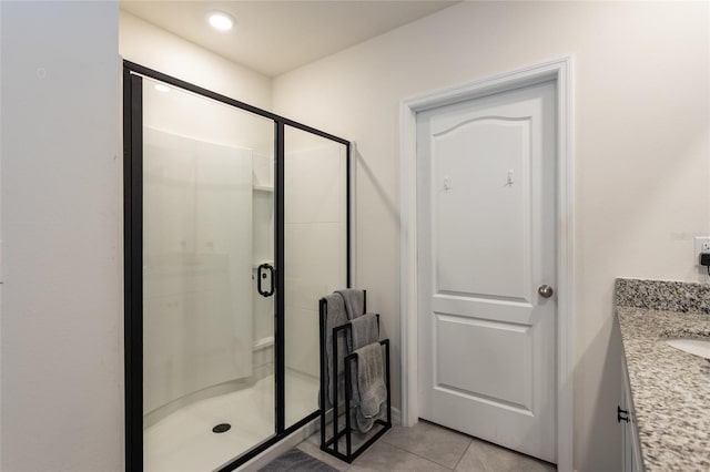bathroom with a shower stall, vanity, and tile patterned floors