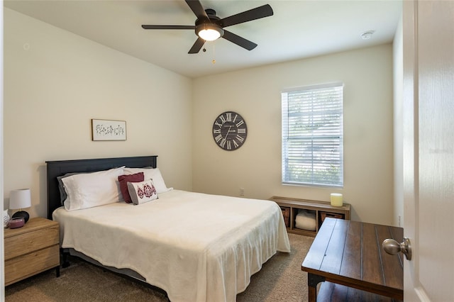 bedroom featuring dark carpet and ceiling fan