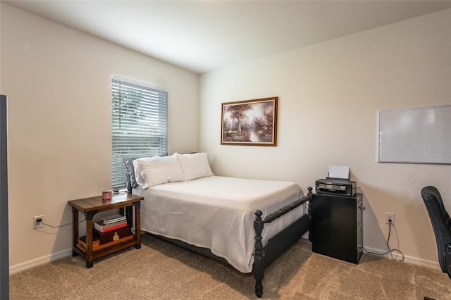 bedroom featuring baseboards and light carpet