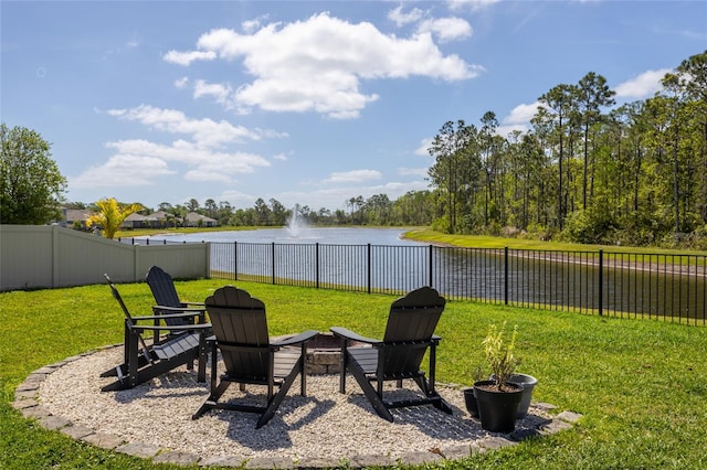 view of yard featuring a water view and fence