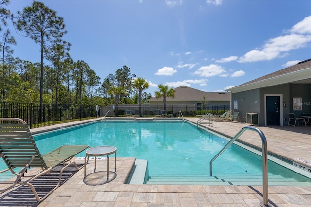 community pool with cooling unit, fence, and a patio