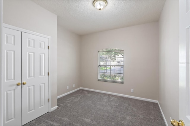 417 Victoria Hills Dr, Deland, FL 32724 - empty room with dark carpet, a textured ceiling, and baseboards