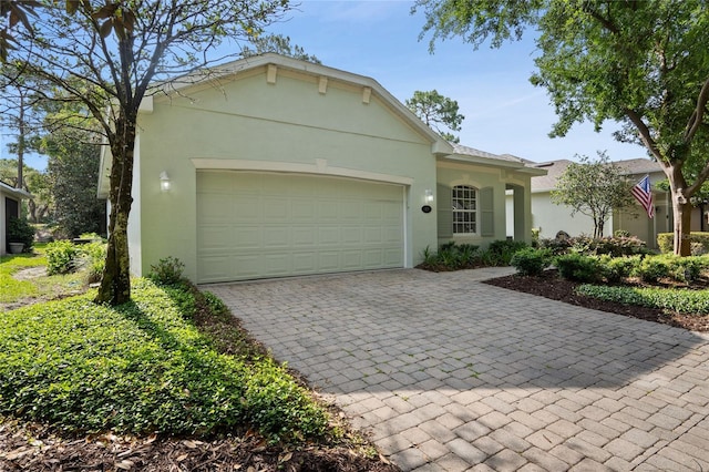 417 Victoria Hills Dr, Deland, FL 32724 - view of front of property with stucco siding, decorative driveway, and an attached garage