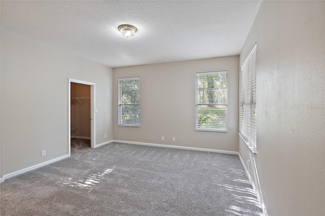 417 Victoria Hills Dr, Deland, FL 32724 - empty room with carpet floors, a textured ceiling, and baseboards