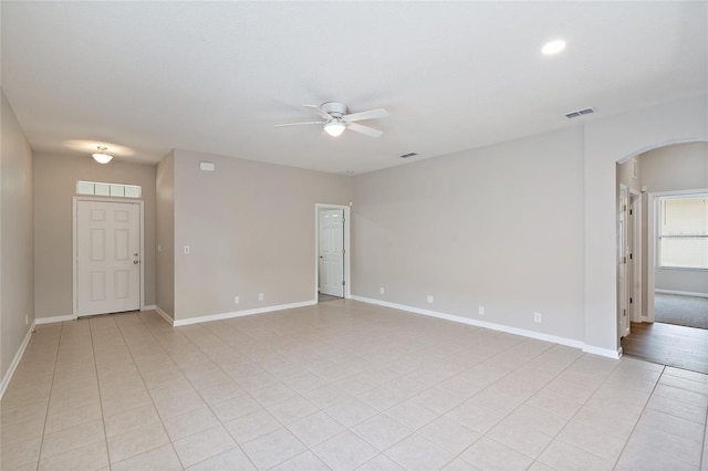 417 Victoria Hills Dr, Deland, FL 32724 - empty room featuring ceiling fan, arched walkways, light tile patterned floors, baseboards, and recessed lighting