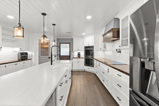 kitchen featuring a sink, stainless steel appliances, dark wood-style flooring, custom range hood, and recessed lighting