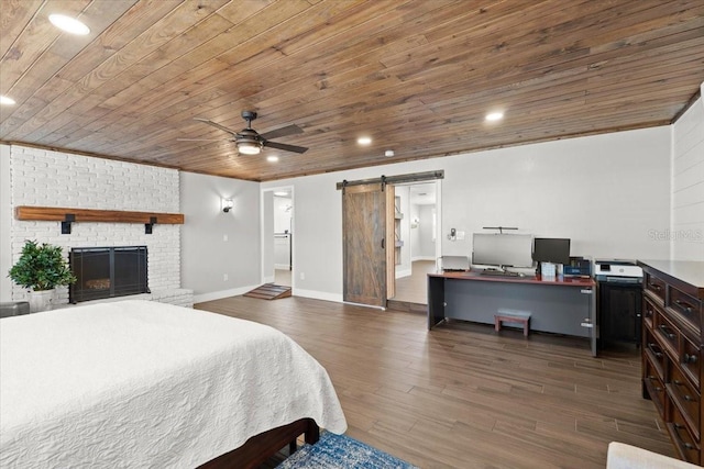 bedroom featuring recessed lighting, wood ceiling, a barn door, and wood finished floors