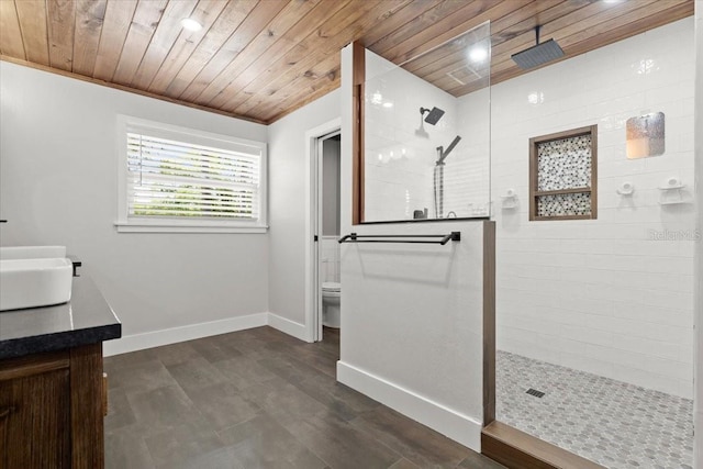 bathroom with wooden ceiling, baseboards, toilet, walk in shower, and vanity