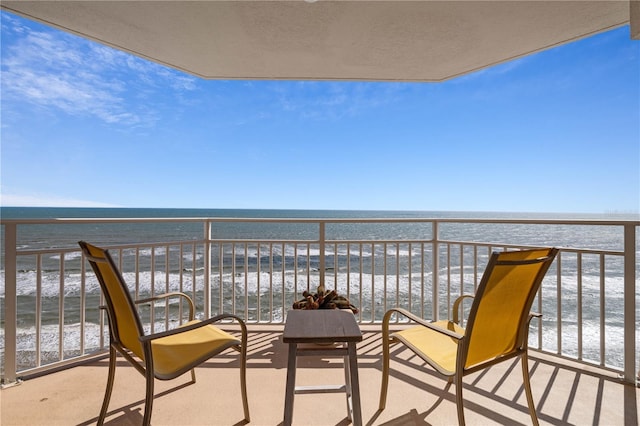 balcony with a beach view and a water view