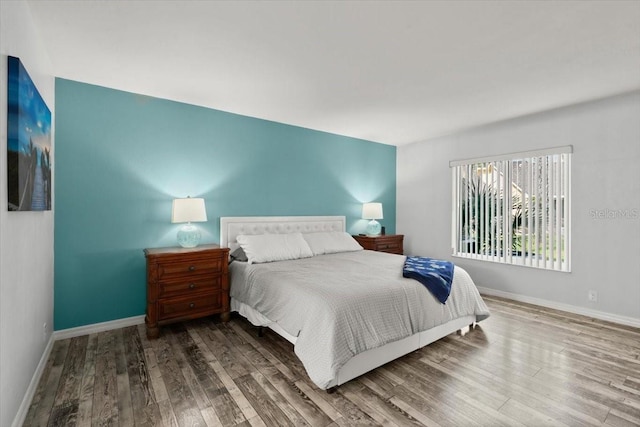 bedroom with wood finished floors and baseboards